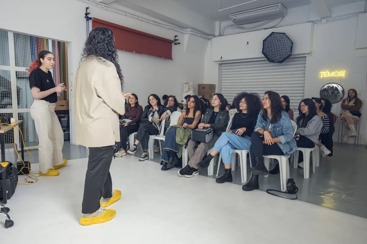 A small audience listens to a speaker at a creative workshop.